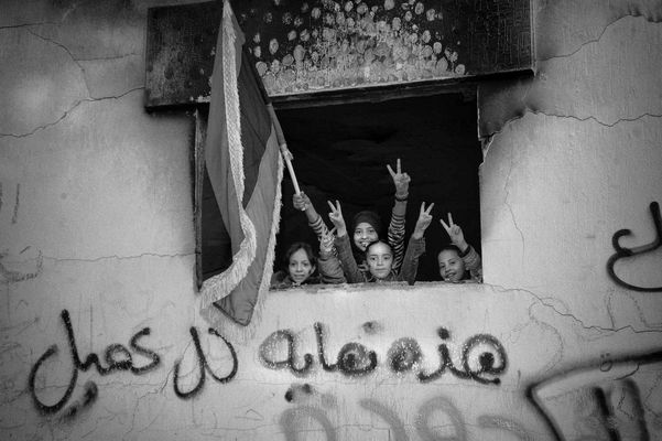 Young people in Benghasi, celebrating in the former Qatiba with flag of liberation