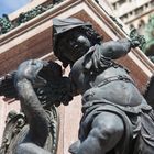 10 - Mariensäule in München, Bronzeputte mit Schwert