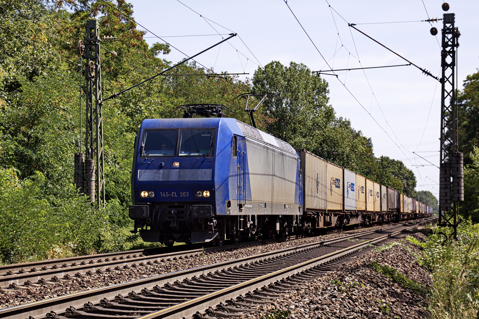 145-CL 203 vor einem Containerzug