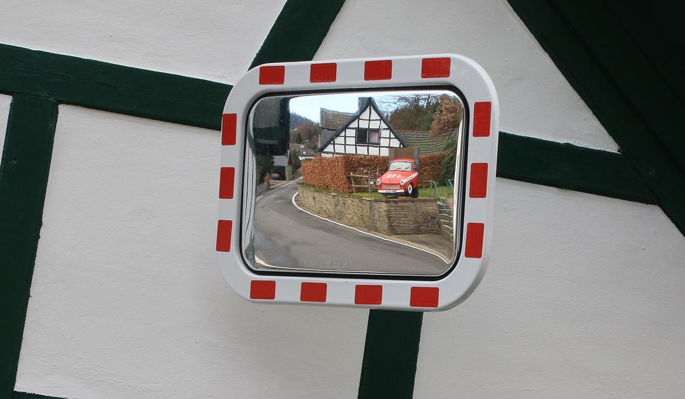 19271 a half piece of Trabbi in a mirror fixed at a house