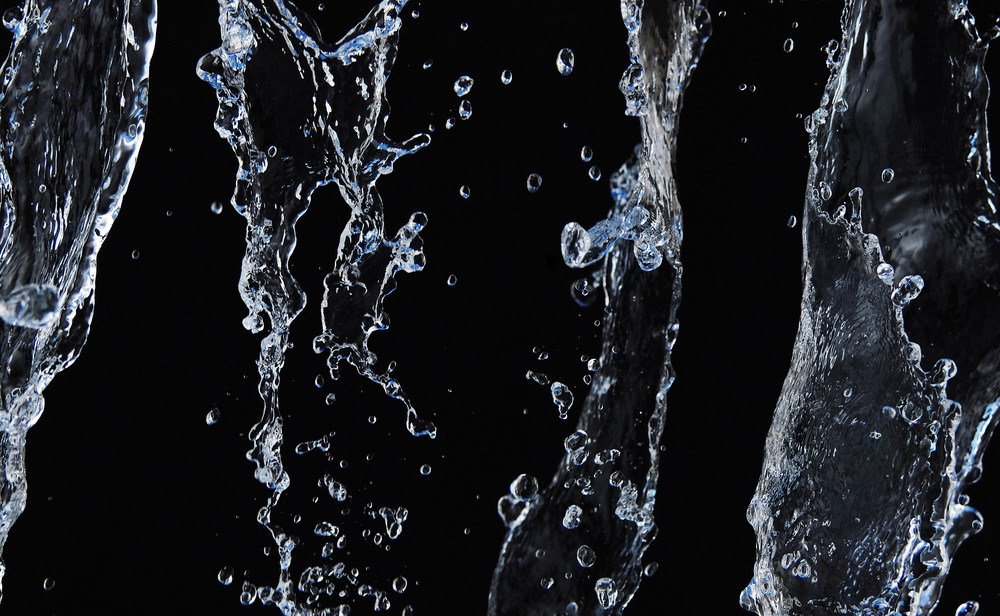 A background with a view of splashing water on black backdrop