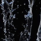 A background with a view of splashing water on black backdrop