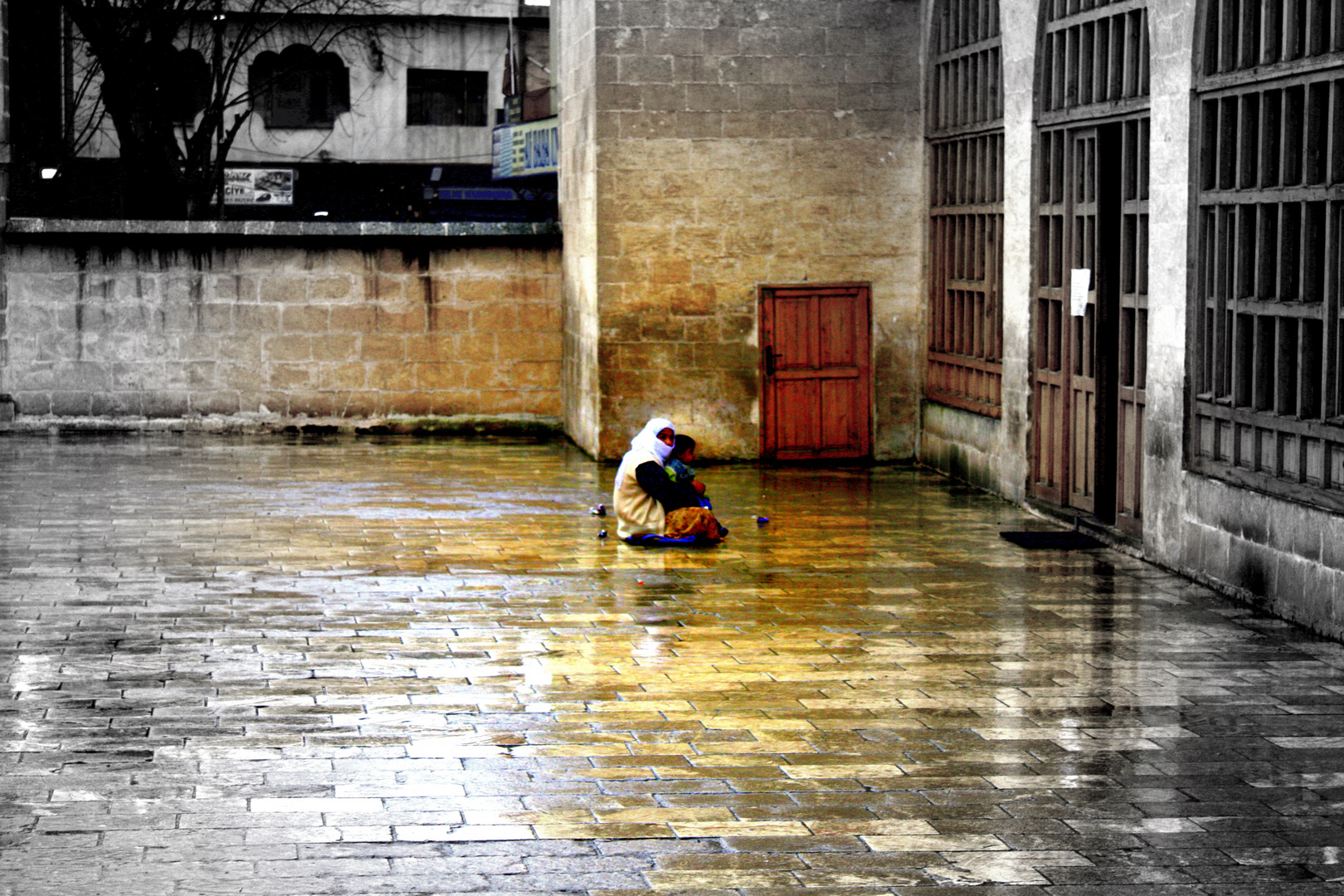 a begger in front of a mosque