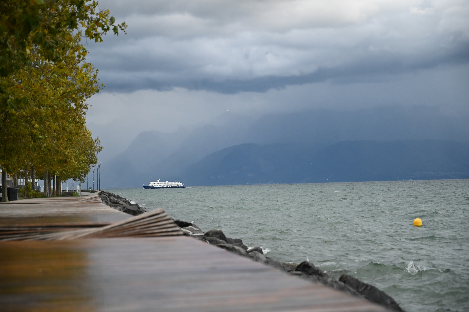 A boat returns to port in gloomy weather.