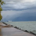 A boat returns to port in gloomy weather.