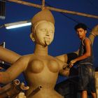a boy making a 12 feet tall idol of goddess