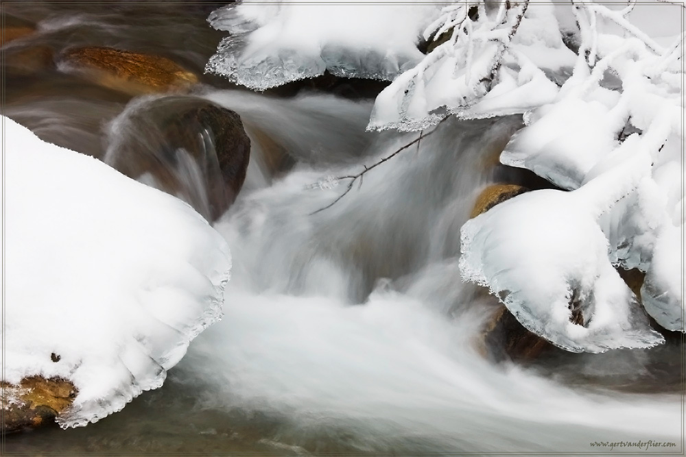 A detail of an icy mountain stream