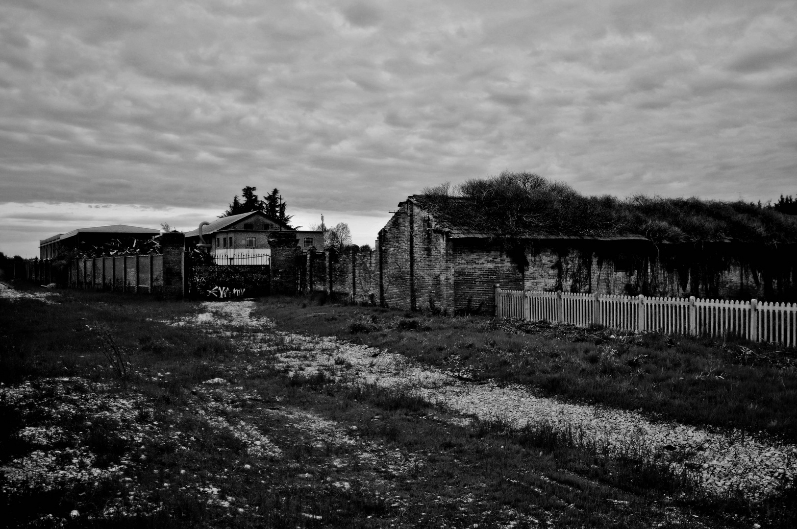 A factory near a station in b/n.