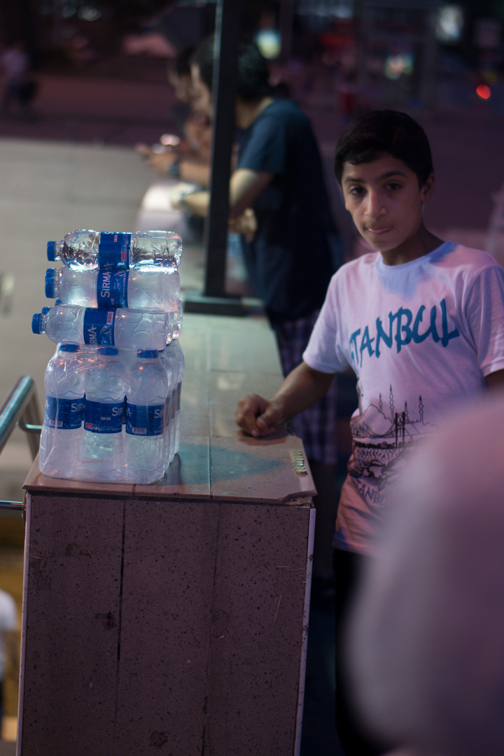 a kid selling water on the street - Istanbul