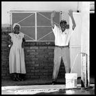 A Lady - watching a man singing and dancing while filling his bucket!