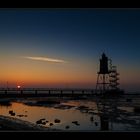 A lighthouse standing in the black