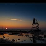 A lighthouse standing in the black