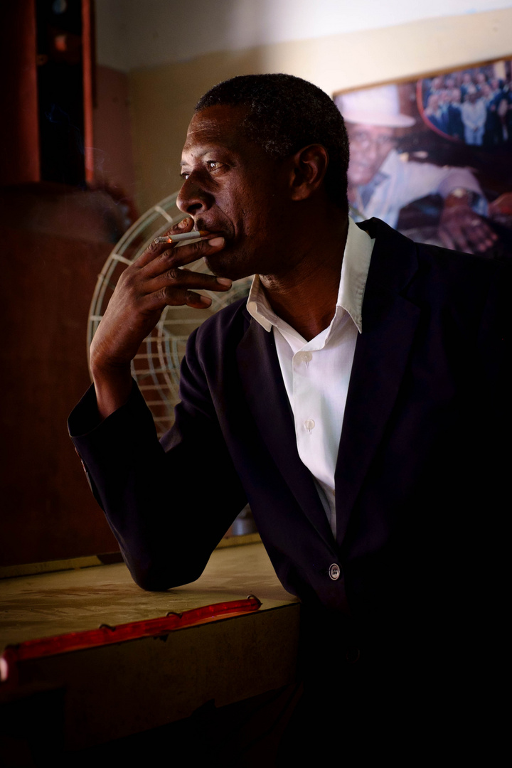 A man smoking in a bar in Havana