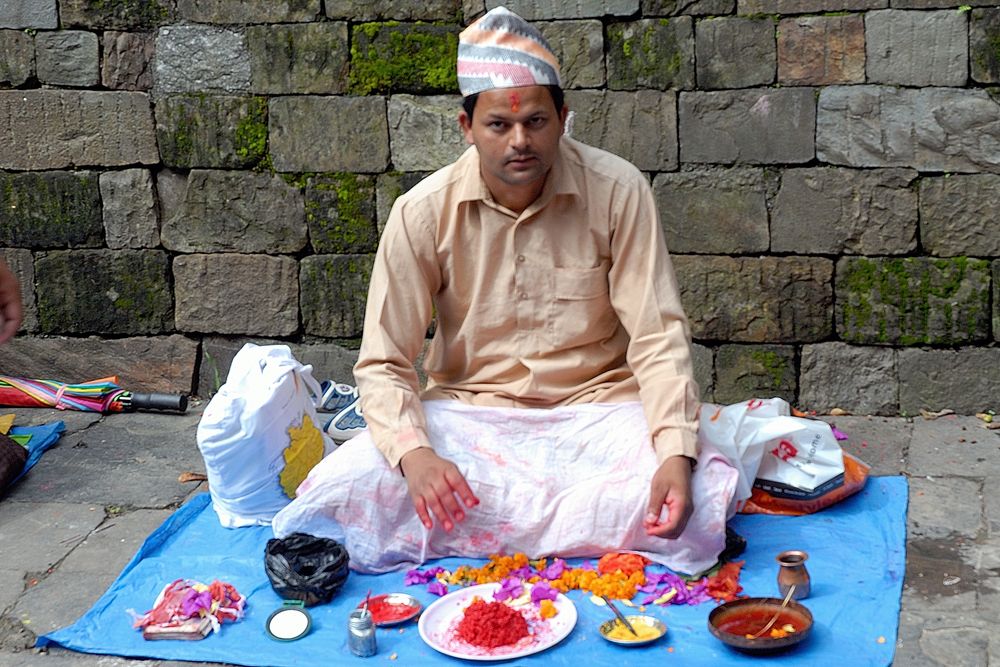 A saint offer to paint a Tikka on the forehead