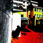 A street in china with woman sleeping on a chair