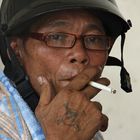 A tatooed protester of the Reds mit helmet after fleeing the camp in Central Bangkok.