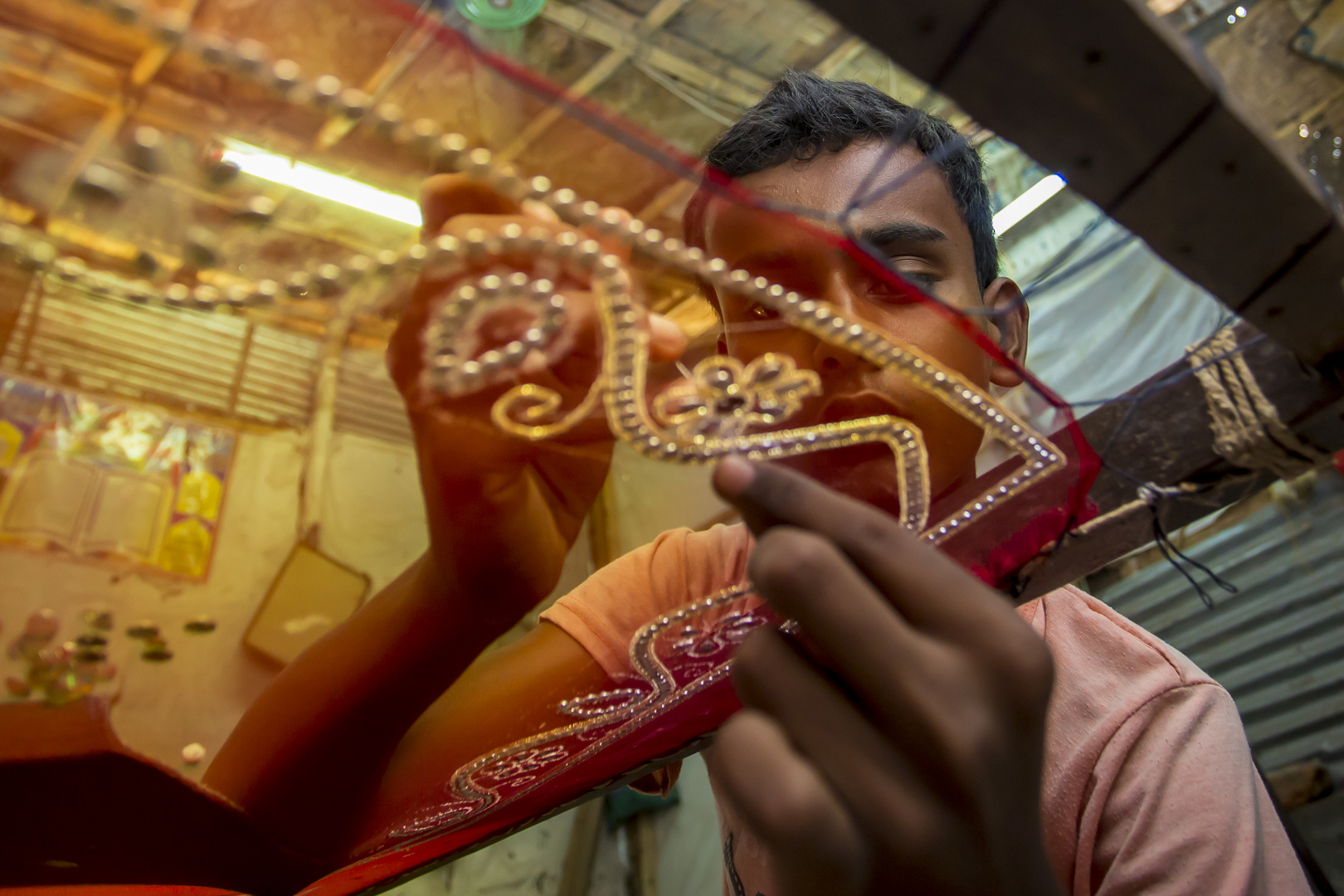 A teenager (Rohit, 12 years) adds detail to a traditional Jamdani saree.