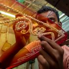 A teenager (Rohit, 12 years) adds detail to a traditional Jamdani saree.