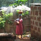 a woman coming from the well