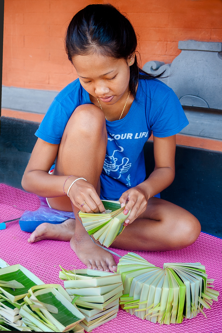 Adii making Canang Sari