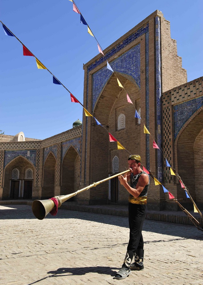 Akrobat spielt ein traditionelles Musikinstrument in Khiwa