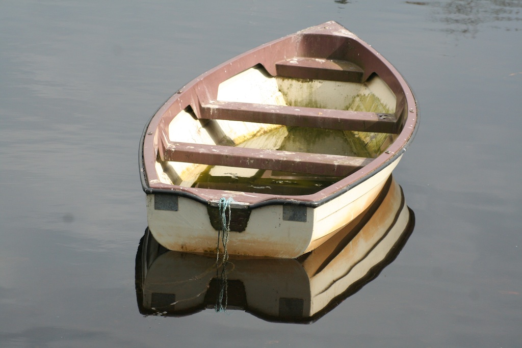 An empty boat on a calm river