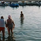 an old couple walking across the sea