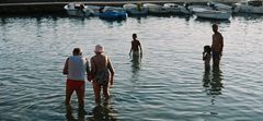 an old couple walking across the sea