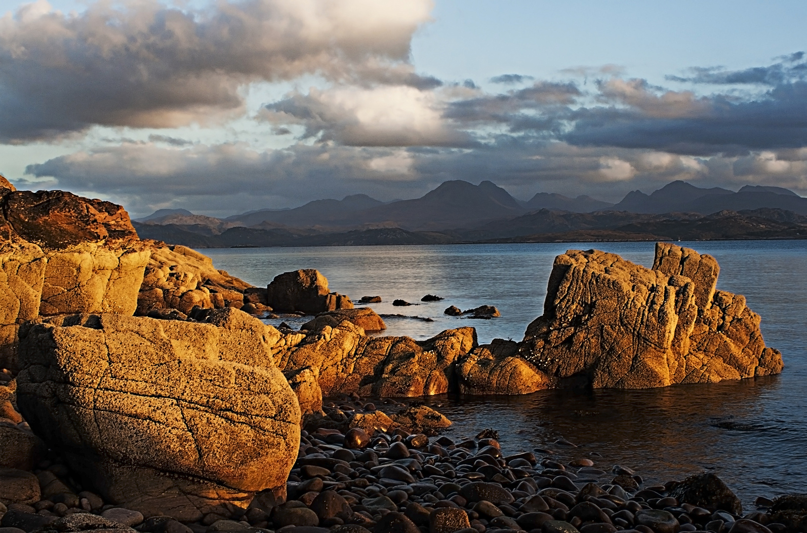 And stand where the peaks meet the sky and the rocks reach the sea