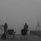 Angler an der See bei dichten Nebel.