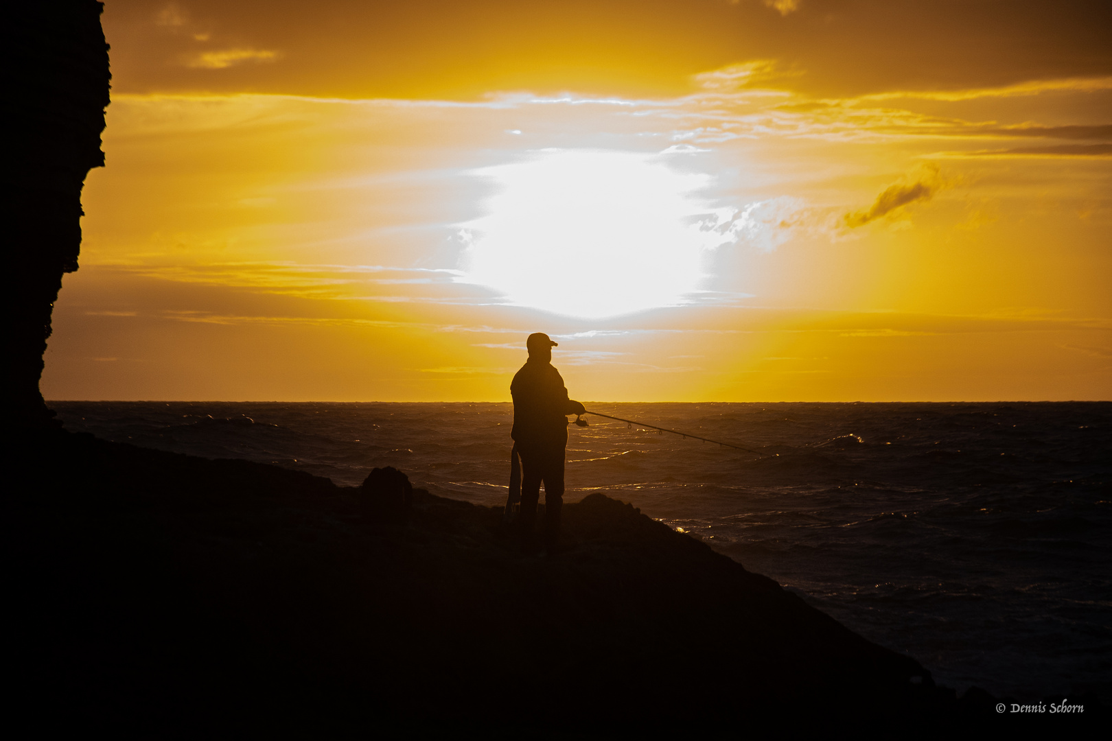 Angler im Sonnenuntergang