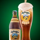 Ayinger wheat beer pouring in a glass