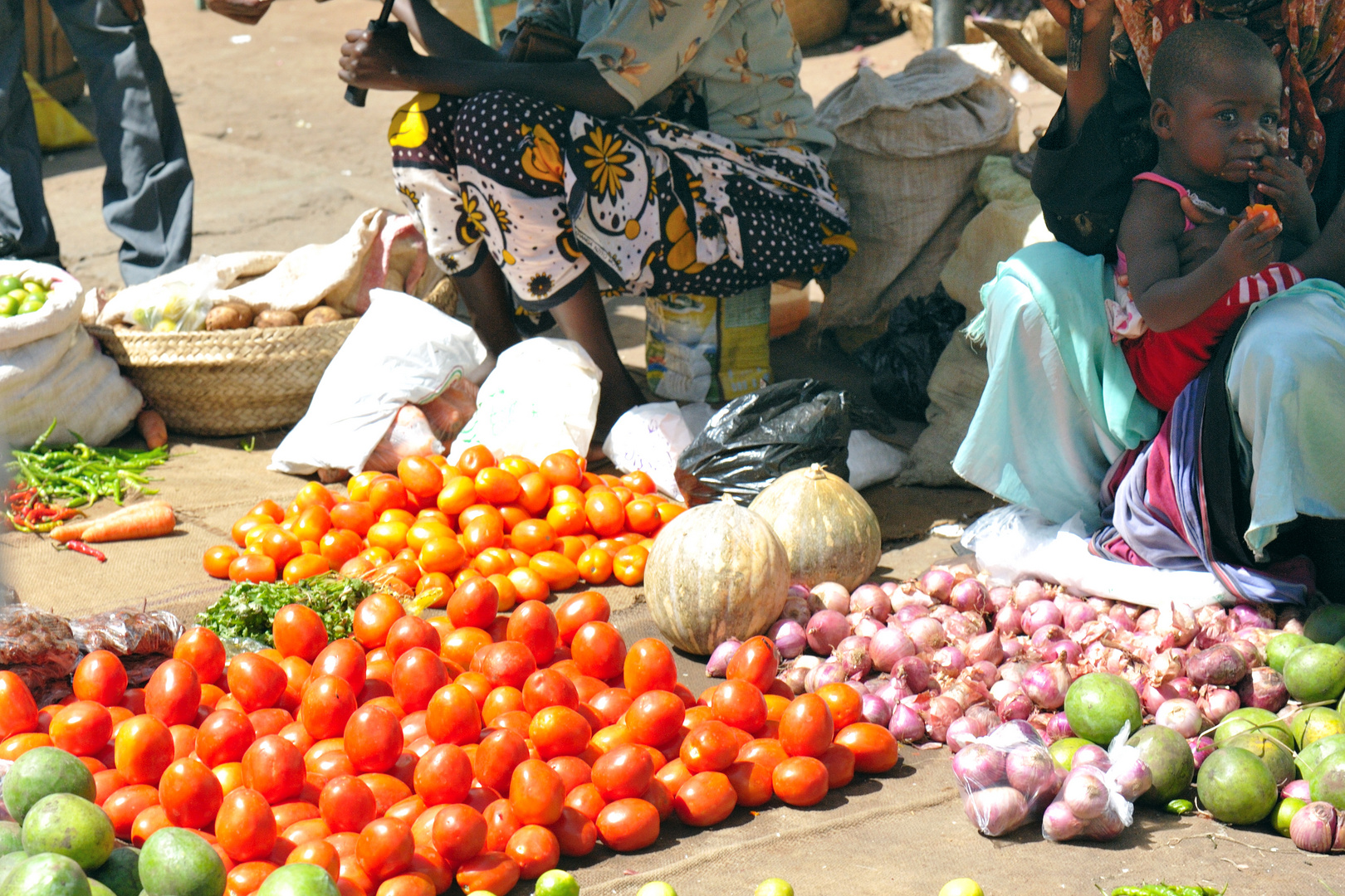 Baby and tomatos, Mombasa market, Kenya