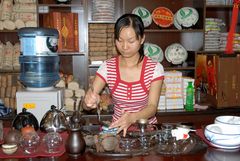 Bai girl preparing tea for us