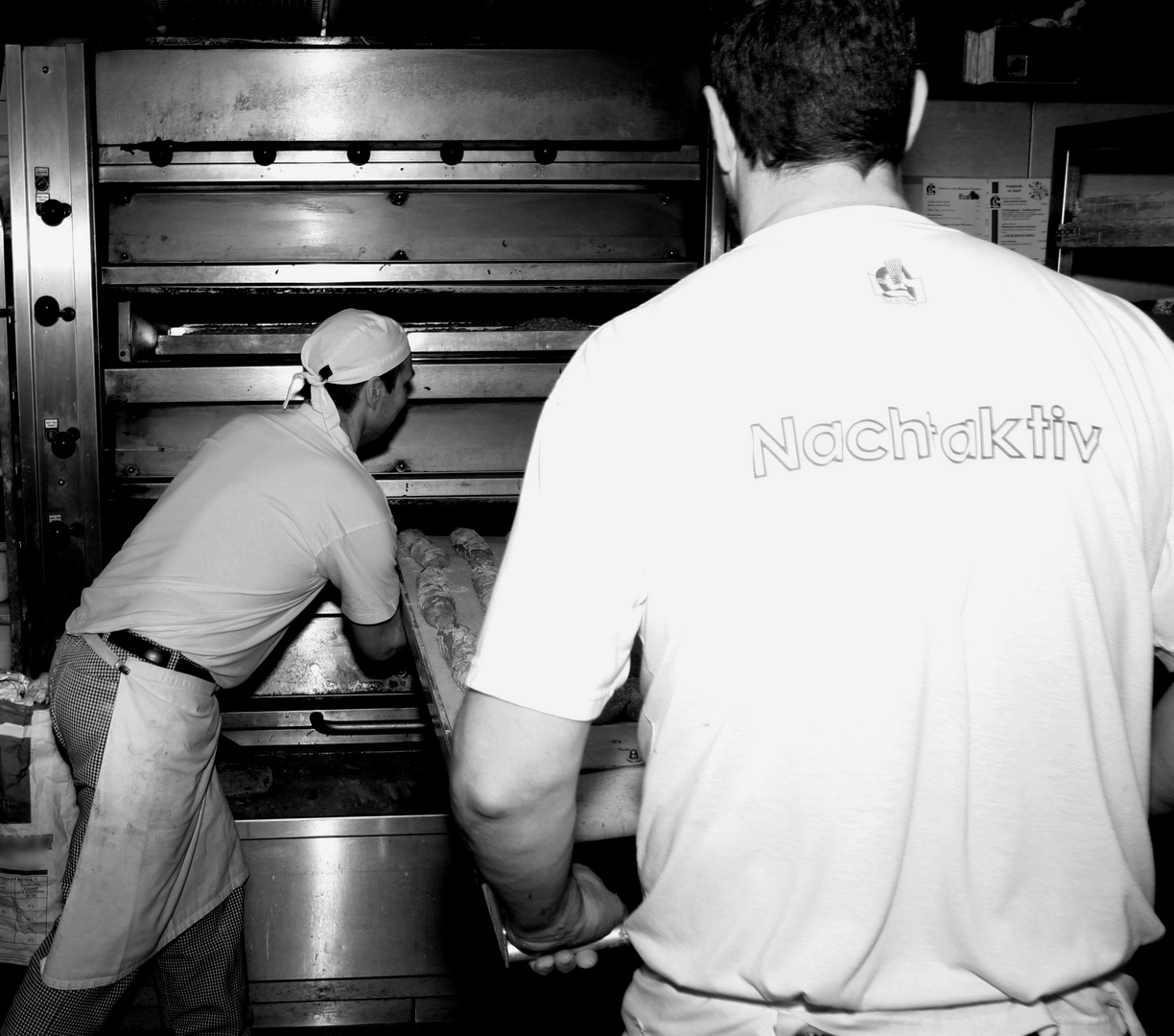 [ baker man is baking bread ]