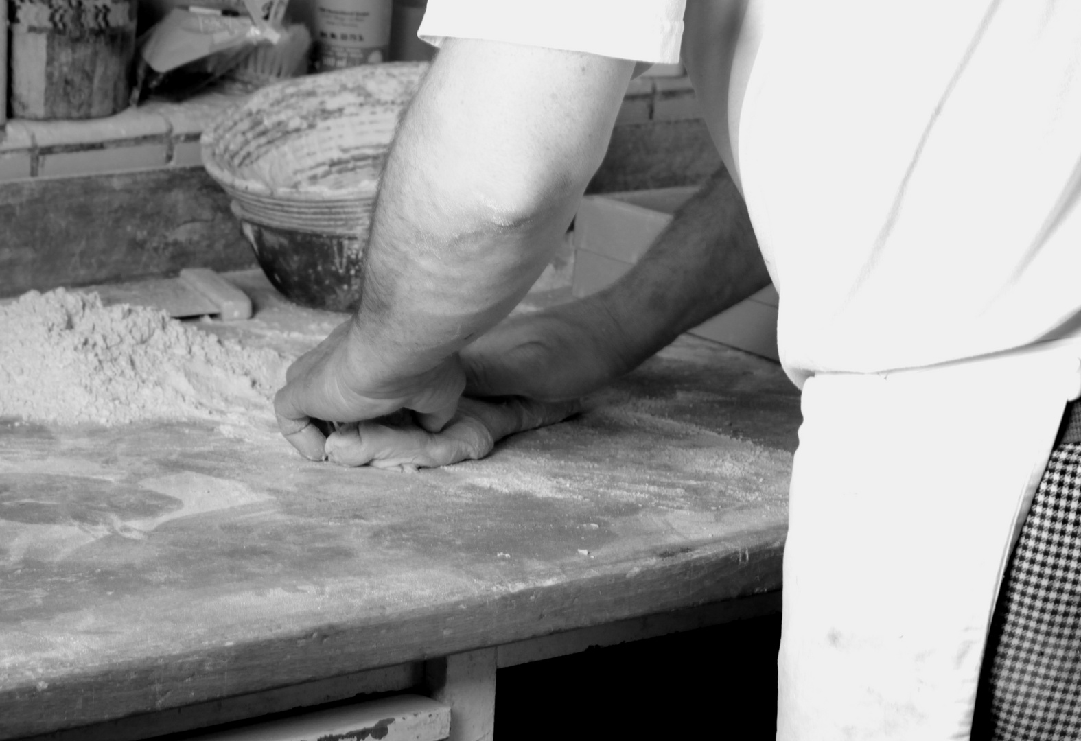 [[ baker man is baking bread ] dispersing by hand ]