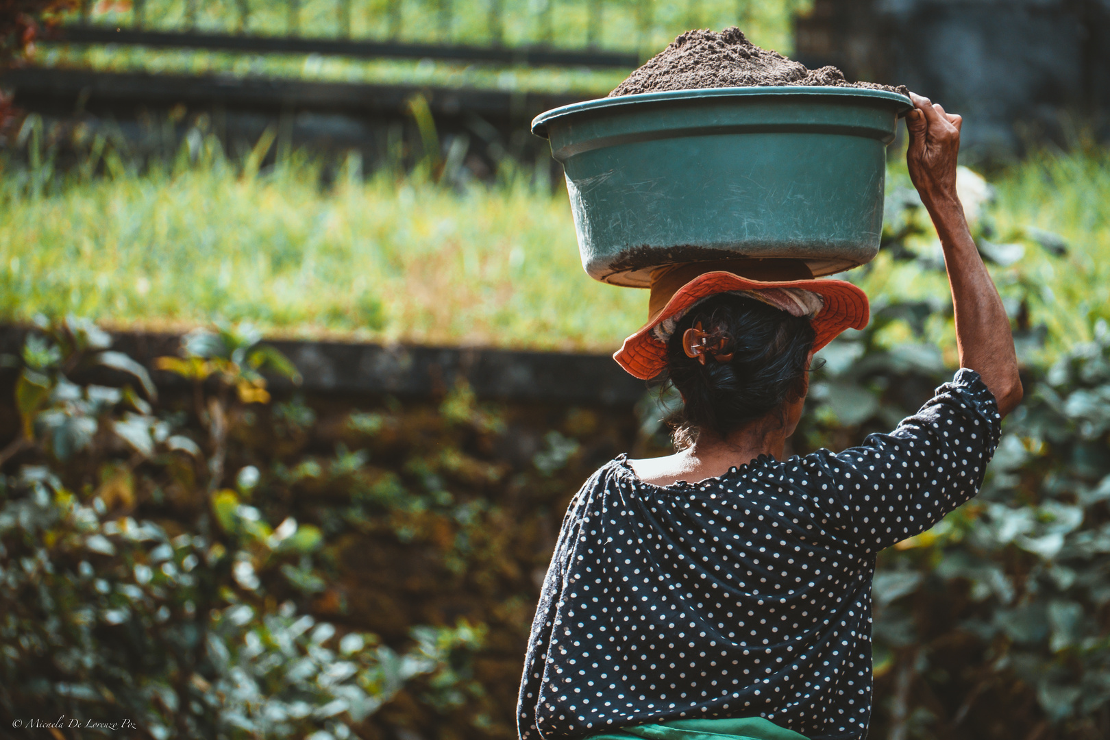 Balinese woman working as bricklayer