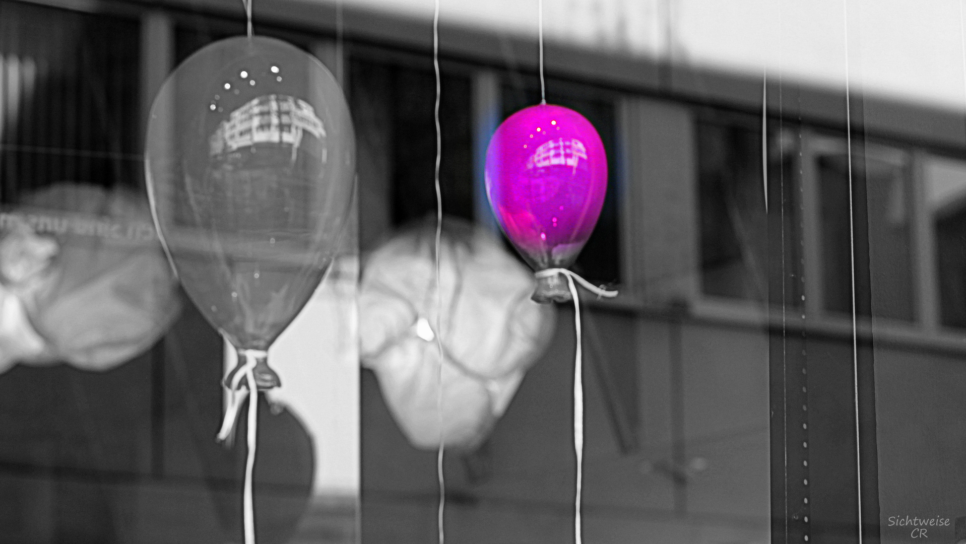 balloons behind glass