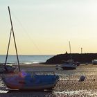 Bateaux en marée basse sous le soleil couchant