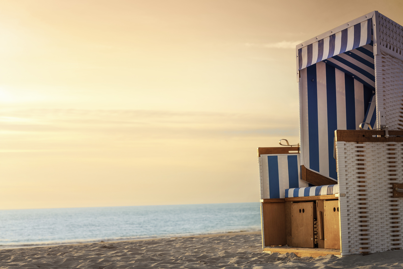 Beach chair and beach at sunset on Sylt. Summer vacation context