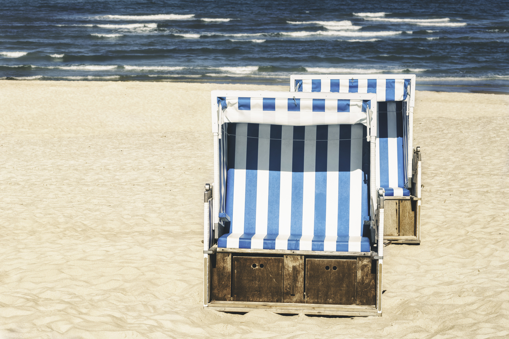 Beach wicker chair at North Sea on Sylt island. Summer vacation