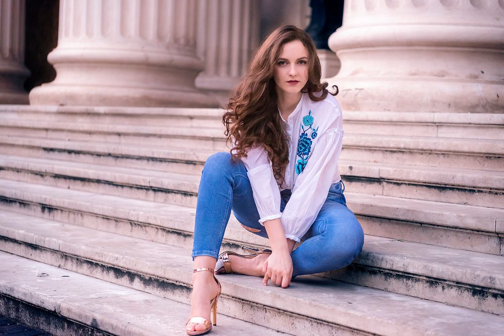 Beautiful caucasian woman sitting on stairs