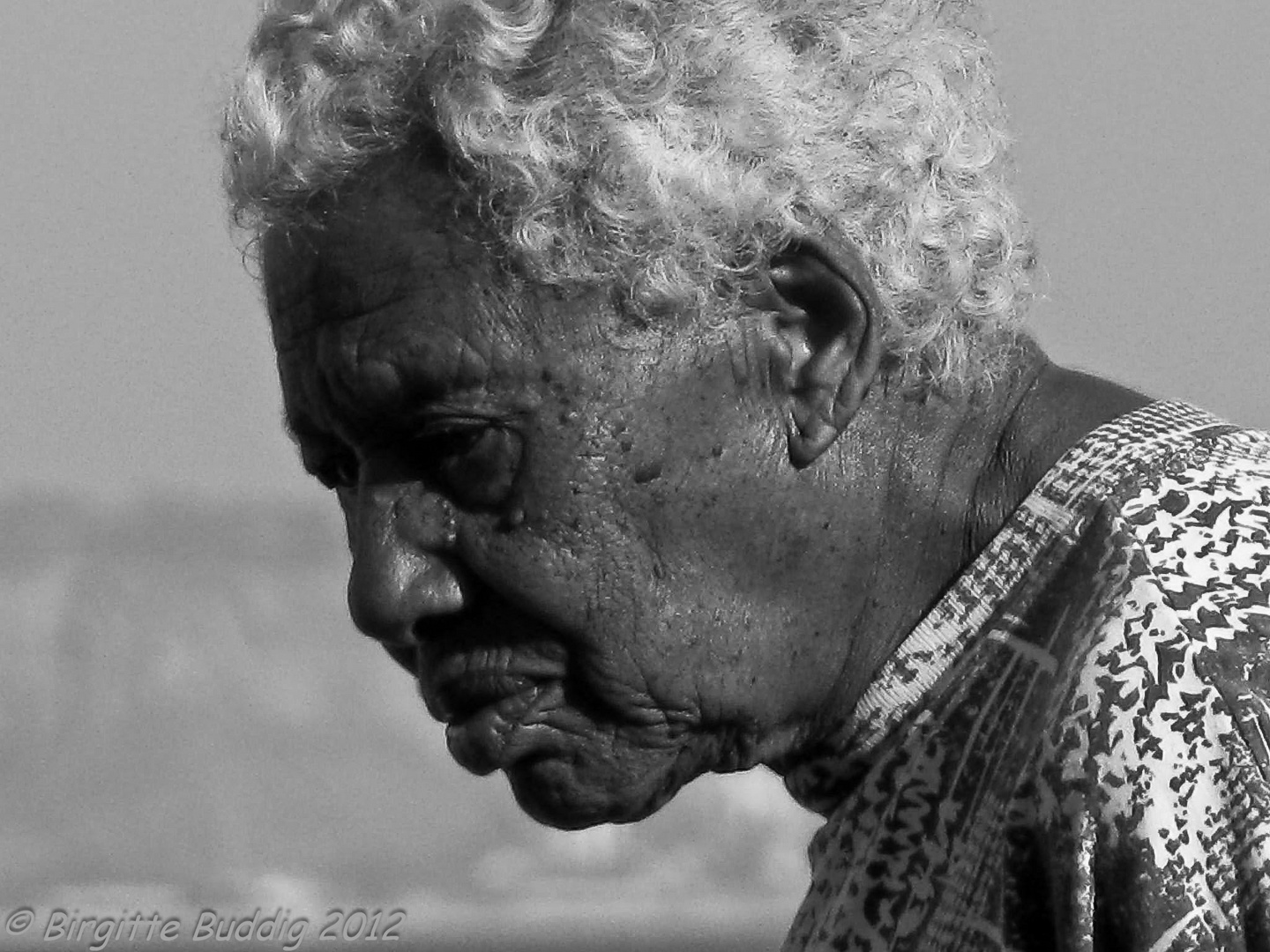 Beautiful old woman at beach by Lisboa, Portugal