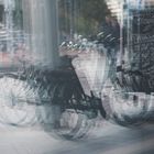 Bicyles mirrored in a Bakery's Door