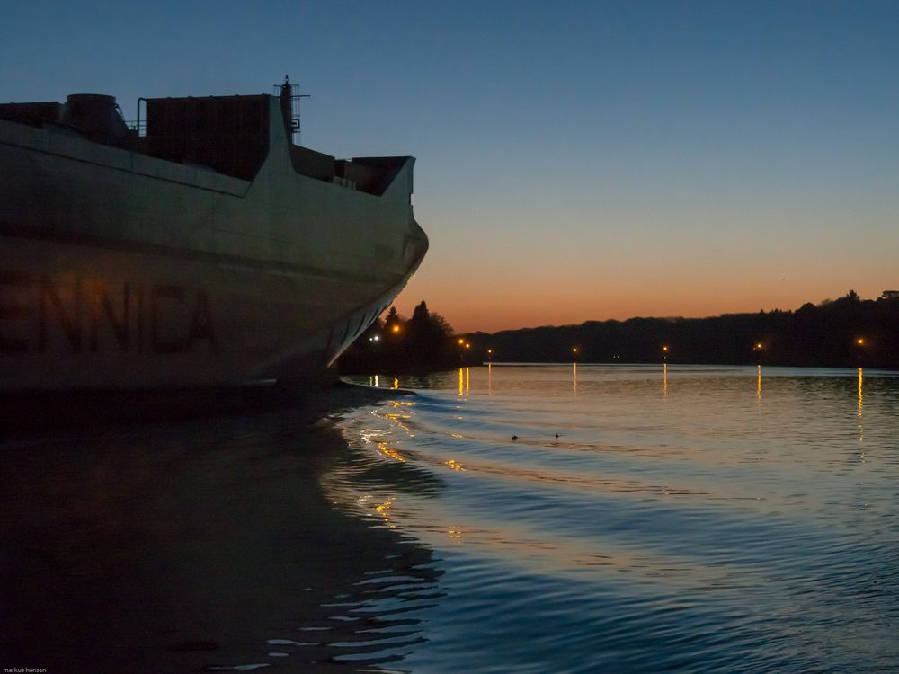 big ship at night in canal NOK