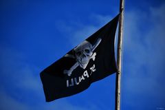 black flag in blue sky