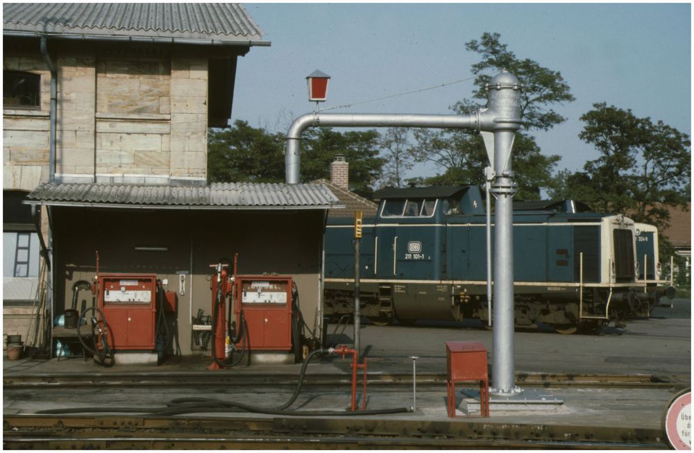 Blaue Diesellok an roter Tankstelle