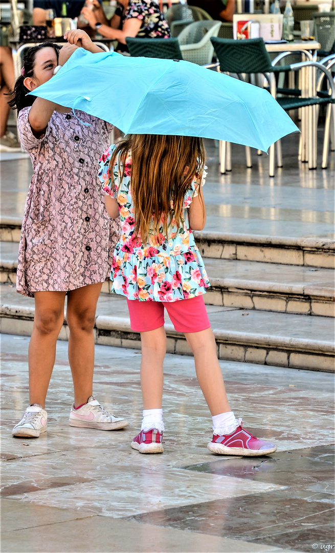 blauer Regenschirm bei strahlendem Sonnenschein