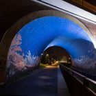 Blauer Tunnel in dunkler Nacht