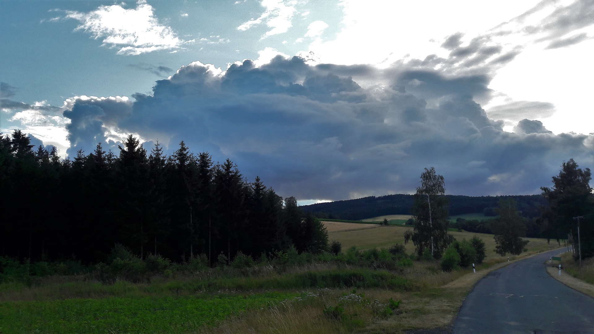 Blick zurück : Regenwolke im  Westwind   "verfolgt" mich beim Radeln